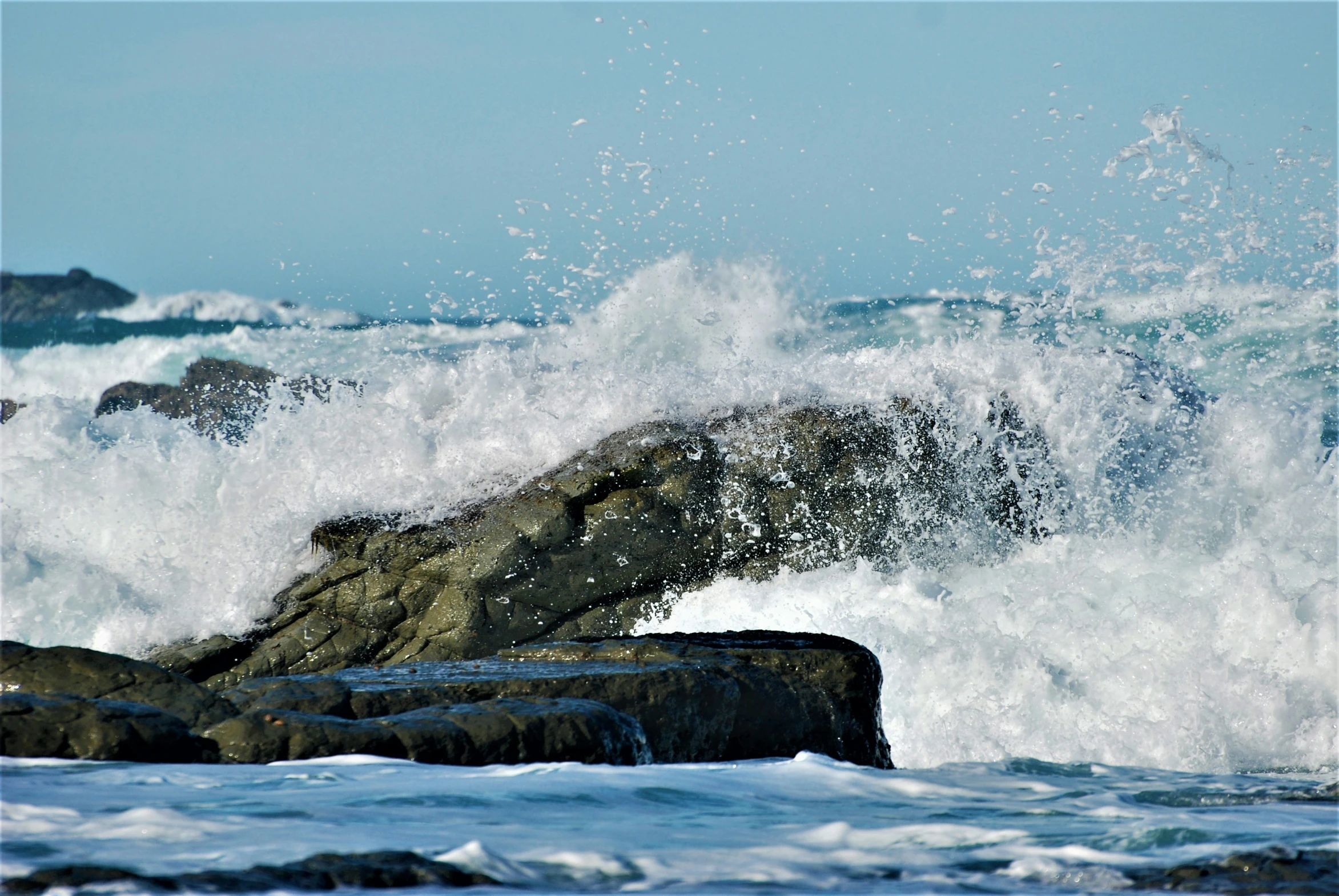 a rough ocean waves on a rock with white foam