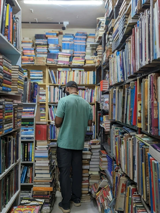 there is an aisle with shelves of books