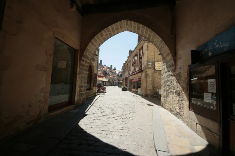 an arched door is opened into an alley way