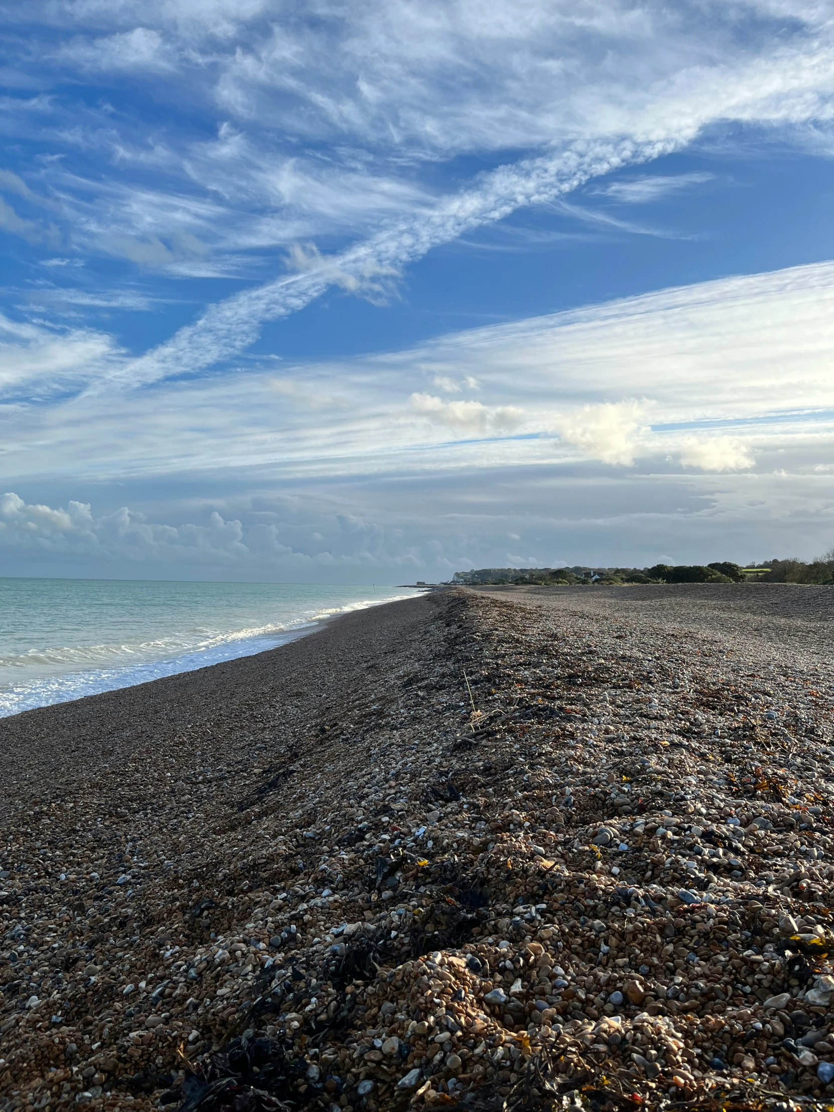 a very close view of an empty beach with waves coming in to the shore