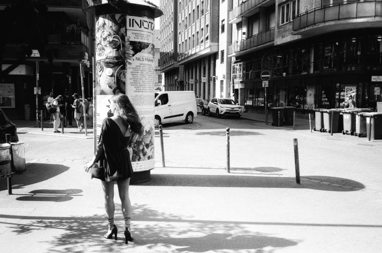 a woman on the street doing a trick on a skateboard