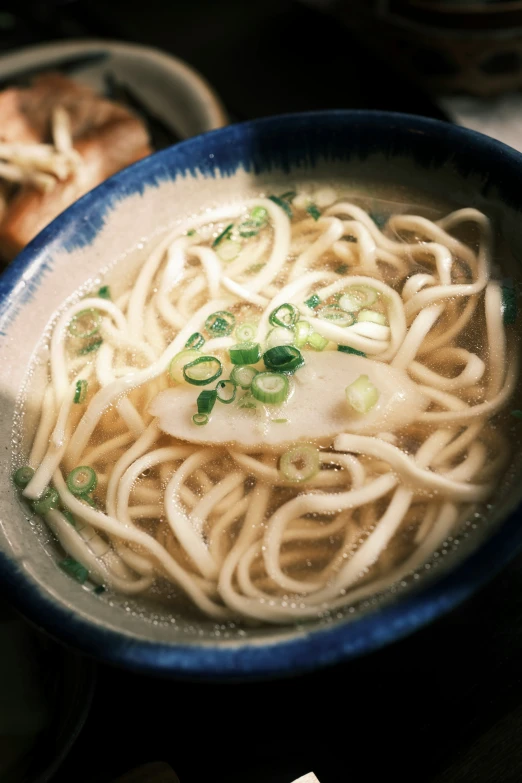 there is soup with noodles in the bowl