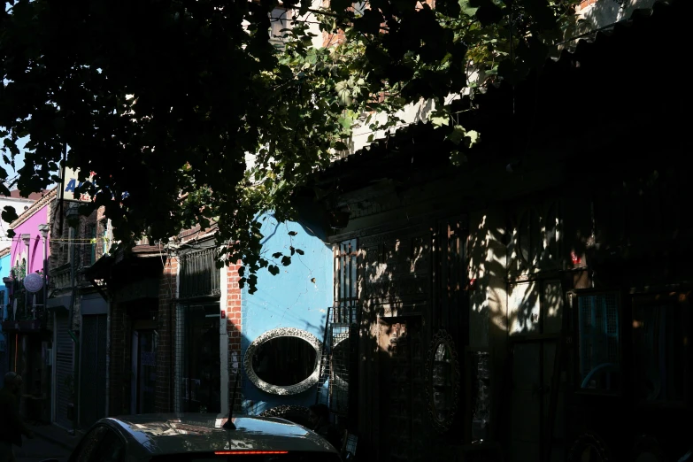 a street scene with the light on and a building with graffiti on it