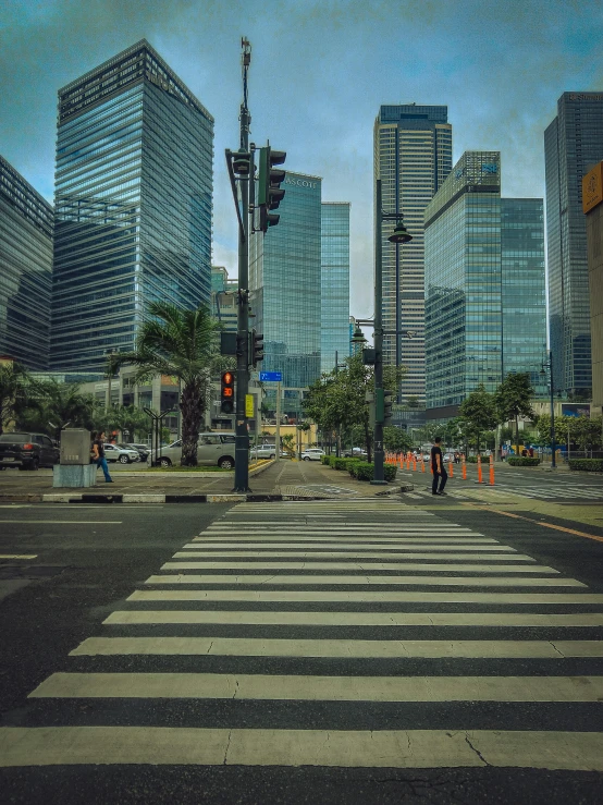 a large group of tall buildings next to a crosswalk