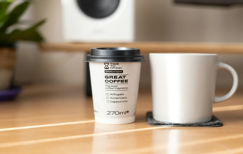 a white cup sitting on top of a wooden table