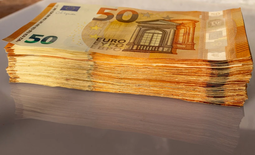 stack of 50 euros bills on silver table