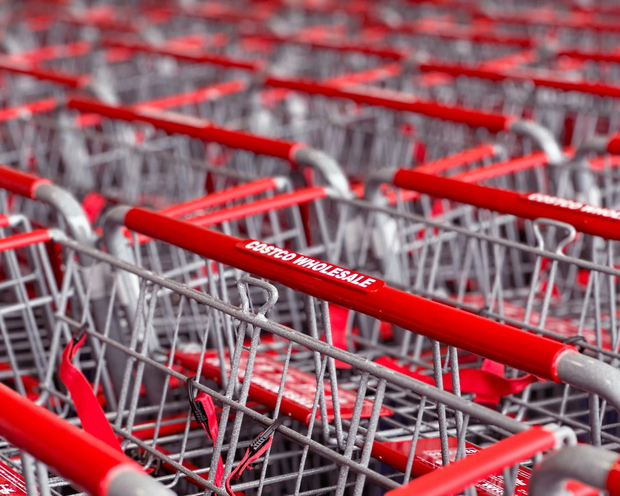 a shopping cart with several red metal carts