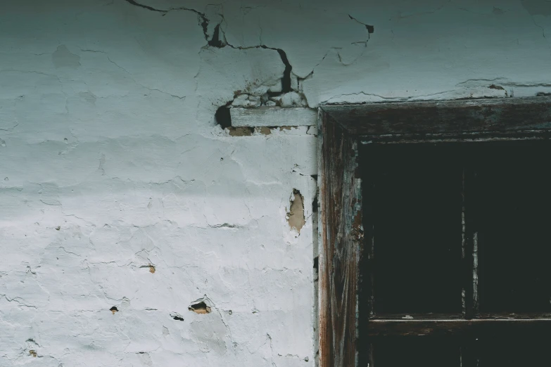 white stucco with small brown and black details next to wooden door