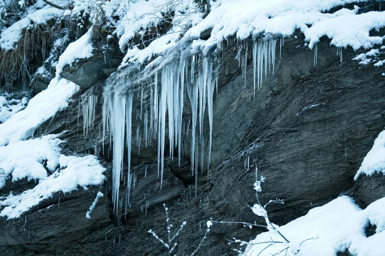 ice hanging from rocks and icicles above them