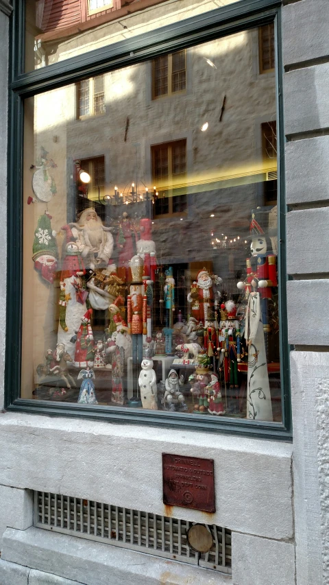 a store front with christmas items on display in the window