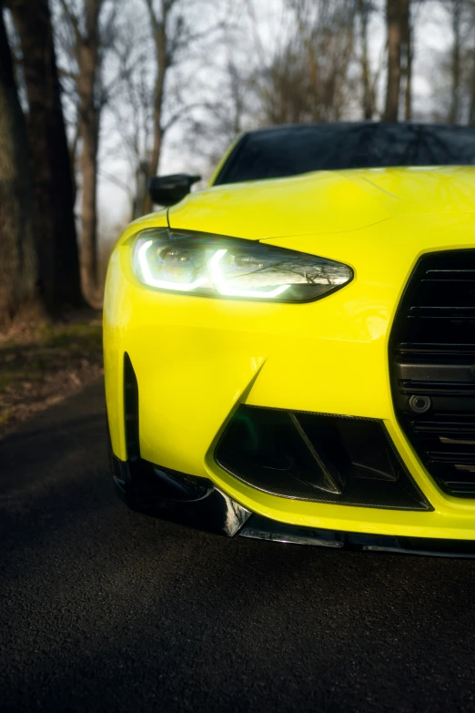 yellow sports car with headlights and the lights on