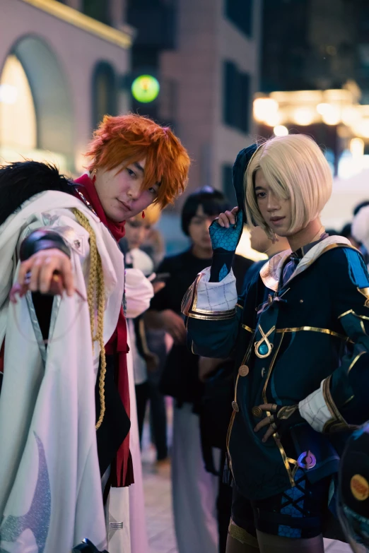 two women in costumes are standing on the sidewalk