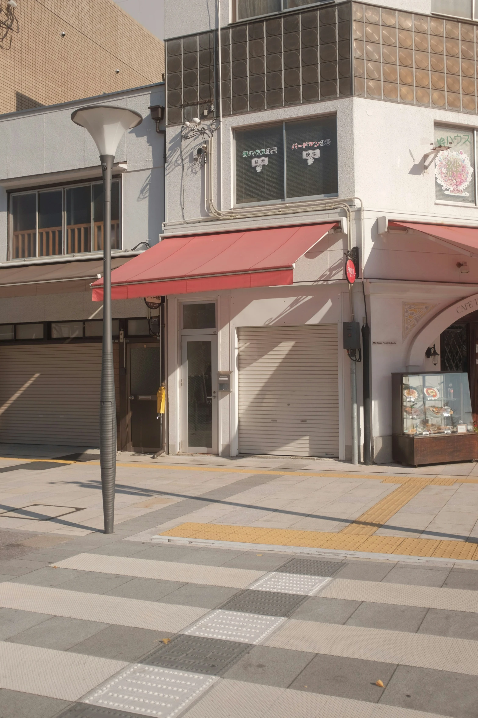 an intersection with stores and shops along the sidewalk