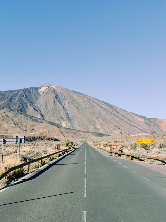 the road passes through a beautiful mountainside on the right