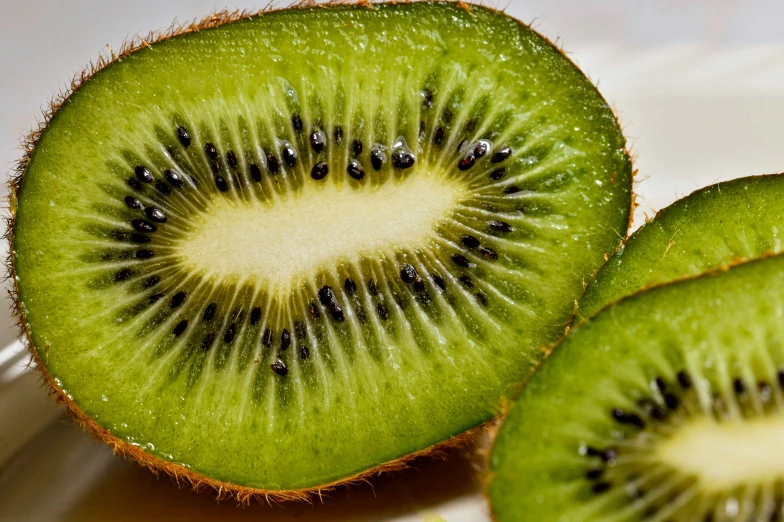 a kiwi that is sliced up on a table