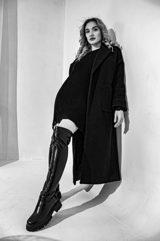 black and white pograph of woman in over - the - knee boots