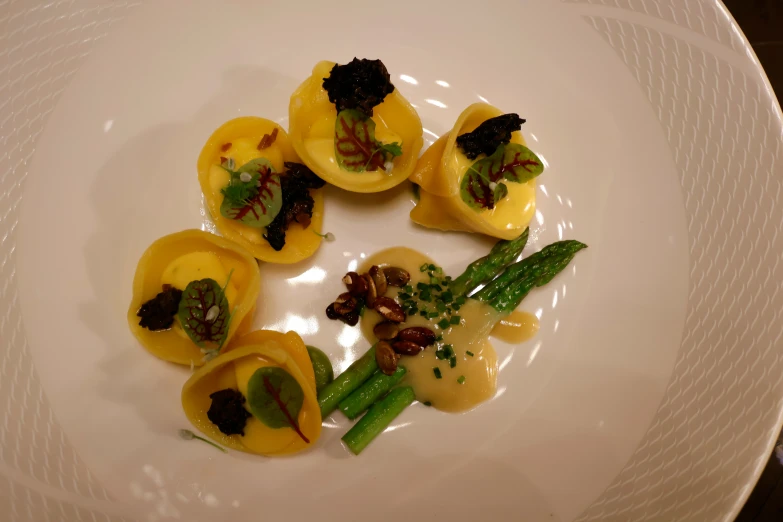 a plate topped with three small pasta ravioli