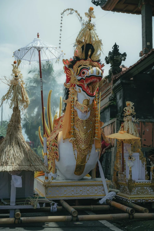 statue of a demon with a large head and headdress