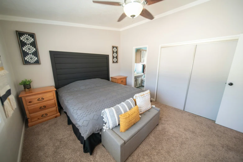 the bedroom has a large bed and a dresser in it