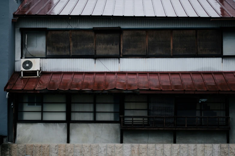 an old building with a brown roof and window panes