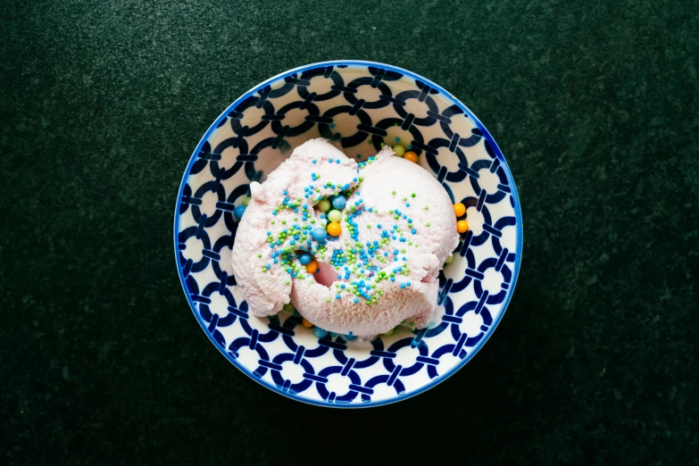 blue and white plate of cookies with sprinkles