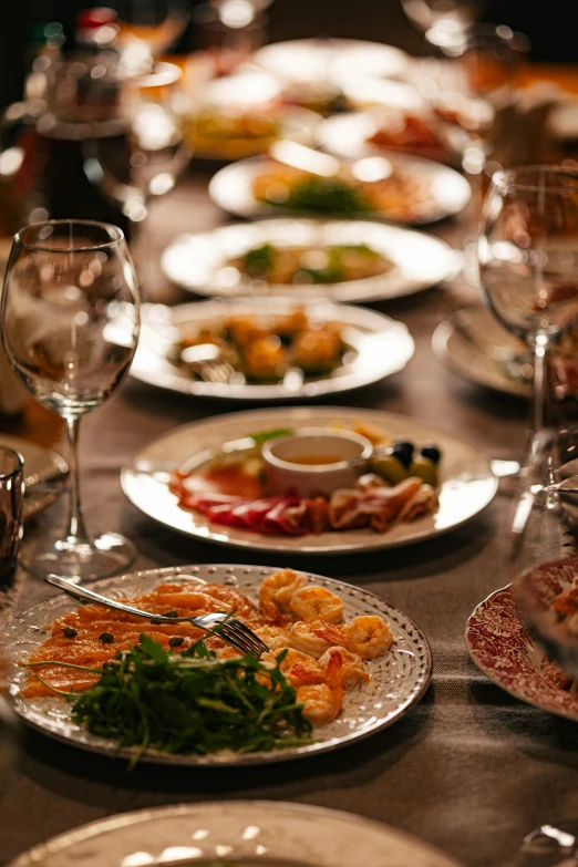 there are plates of food on the dining table