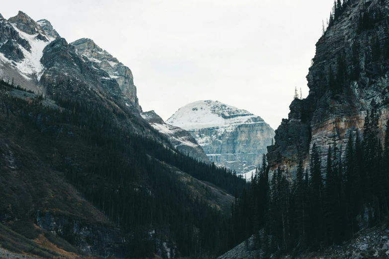 a scenic view of mountains and snow capped peaks