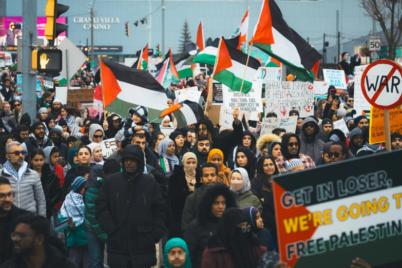 many people are in a large protest with flags