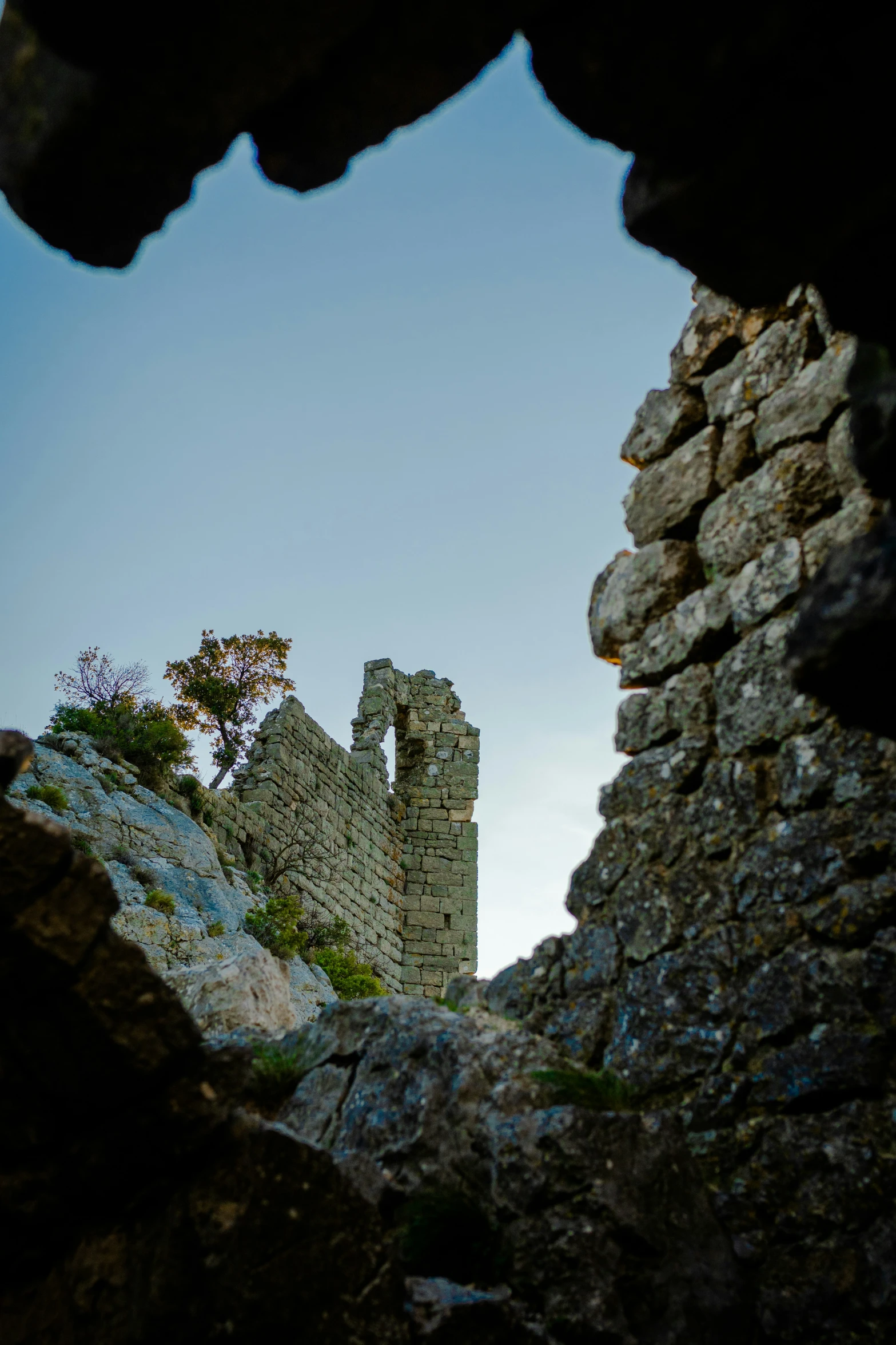 a view from behind the rocks of an old building