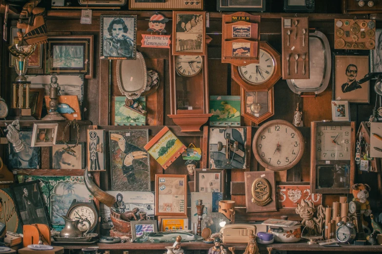 a wall with many clocks, and pictures on it