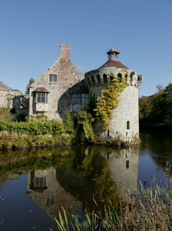 a large building next to water and trees