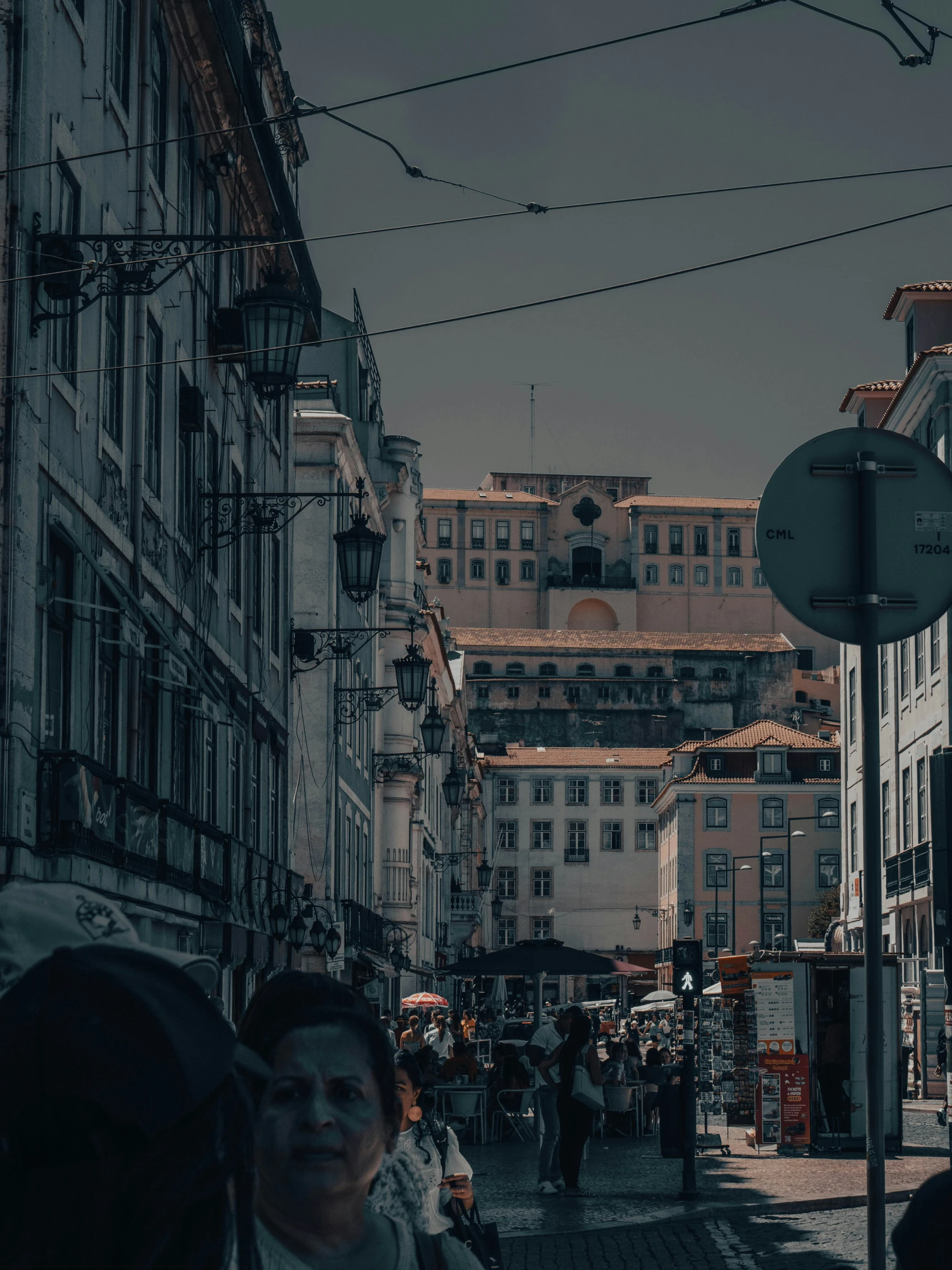 some people on an alley way and a clock tower