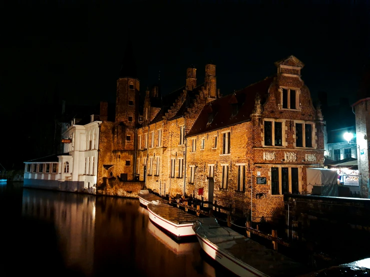 a long building on the side of a river at night