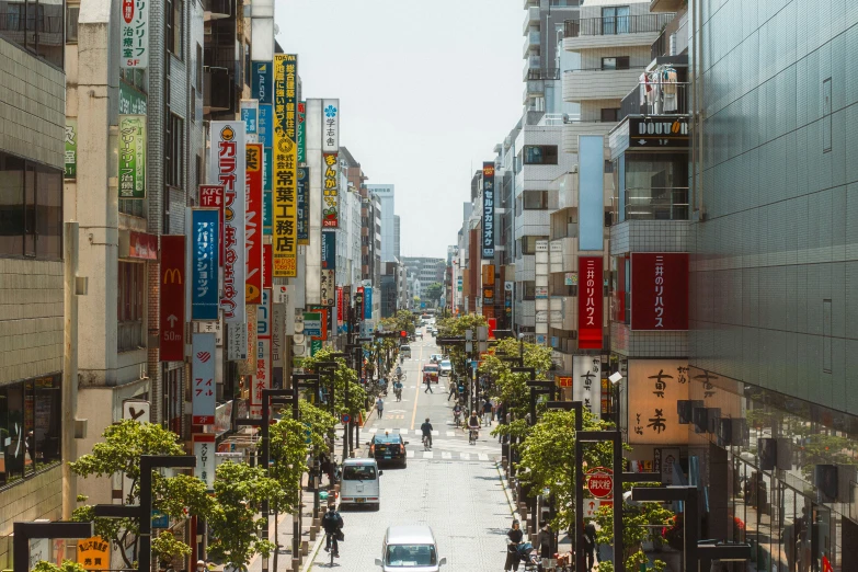 a wide city street filled with people and signs