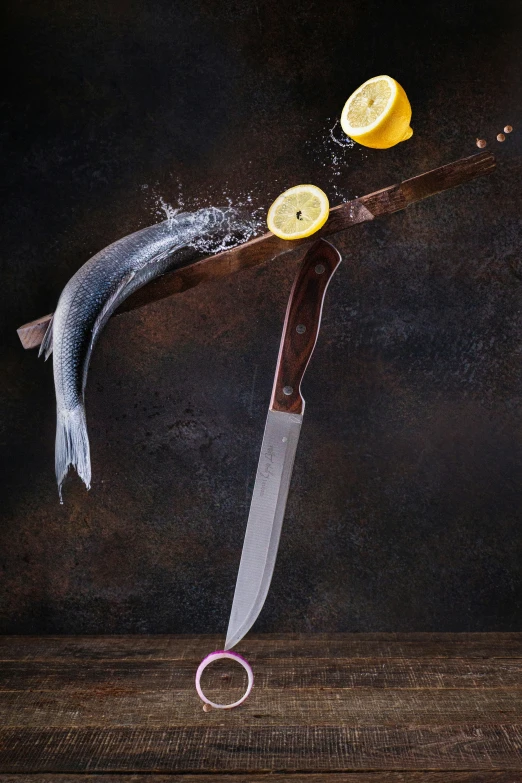 a knife and lemon are being sliced on top of a piece of wood