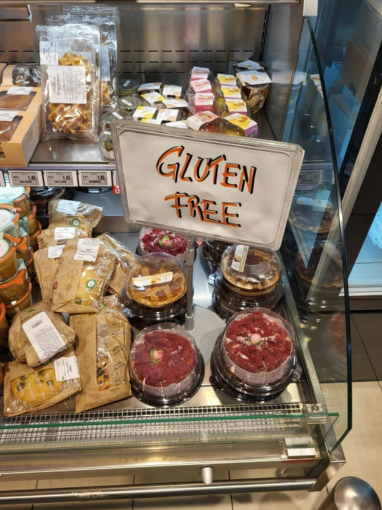 there are various snacks and other items in a food display case