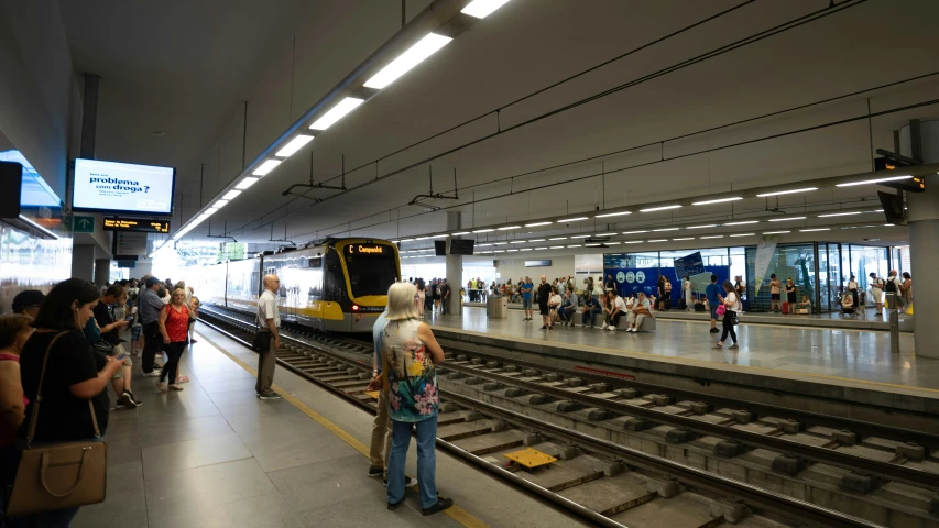 people waiting at the subway station for their train to come