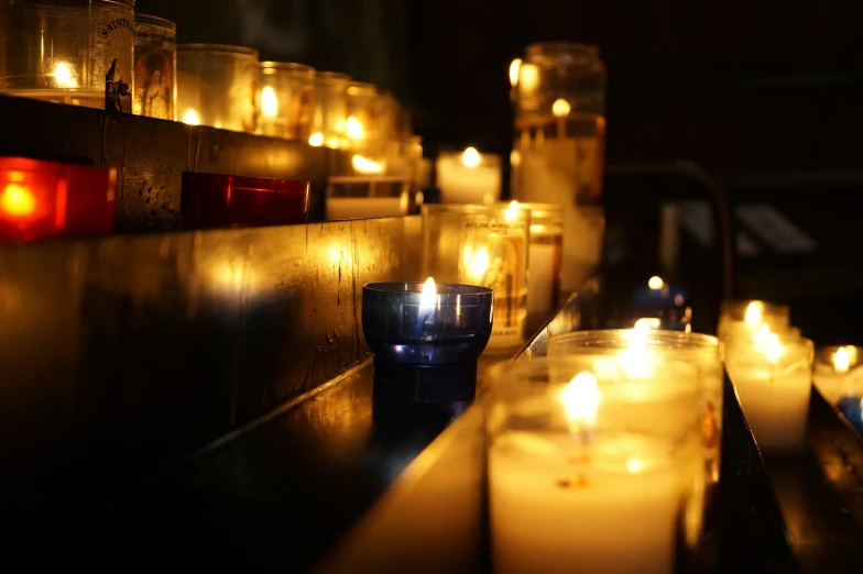 lit candles and candles on the side of a building