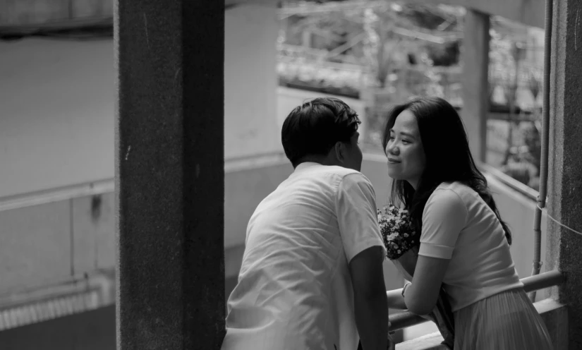 man and woman standing together looking at each other