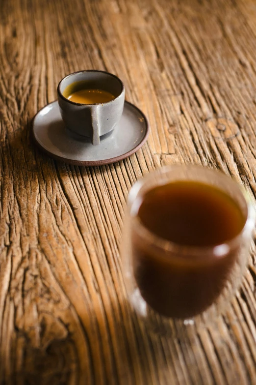 a teacup sitting on a saucer with syrup in it