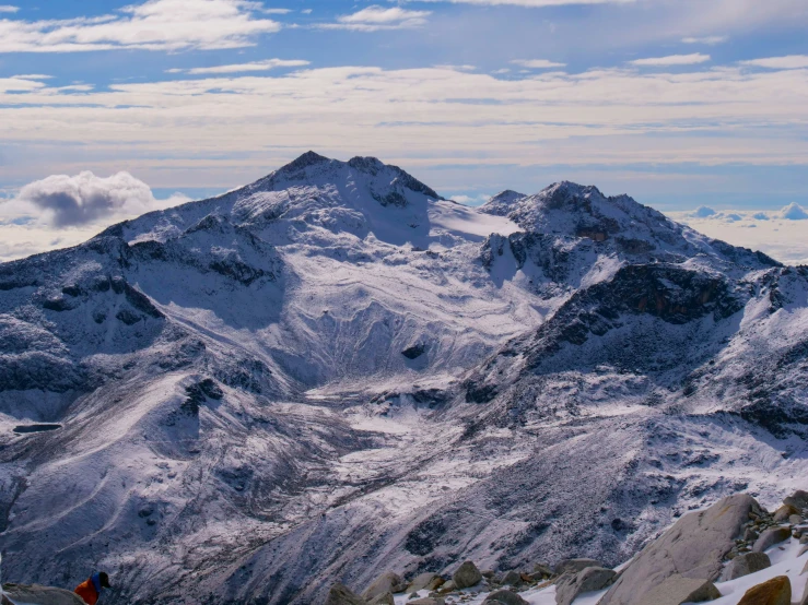 two snow covered mountains are seen in the distance