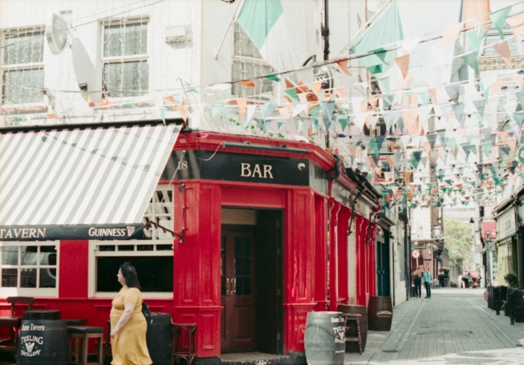 this woman is walking past a restaurant called bar