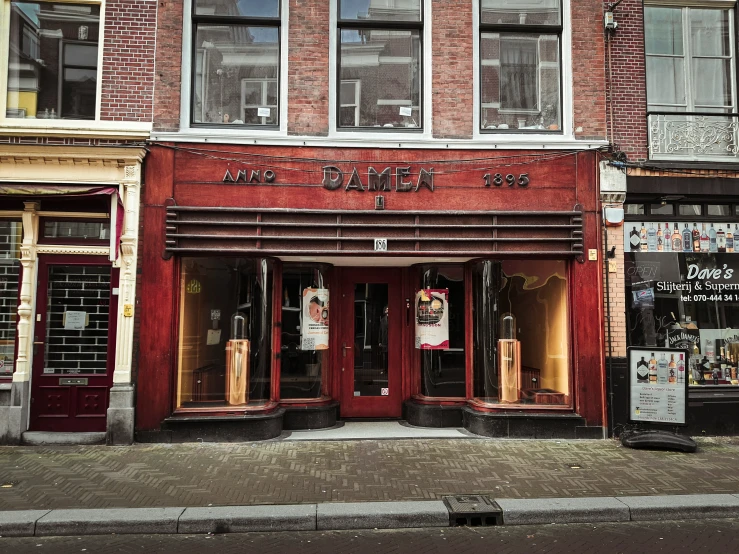 a small store front has two windows and some signs