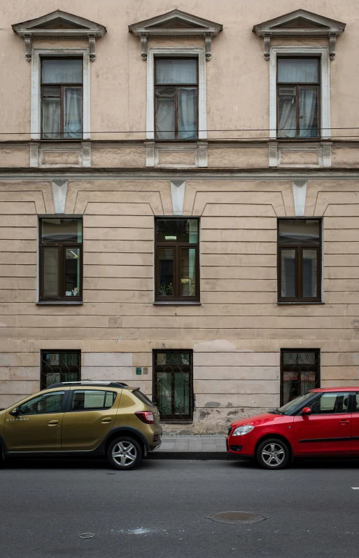 two cars parked in front of a building