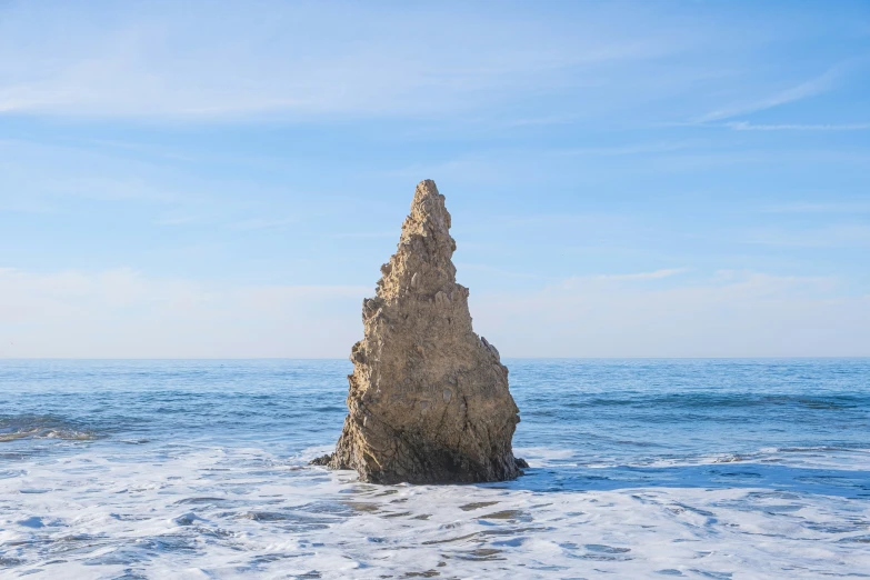 a sand column sticking out of the white snow