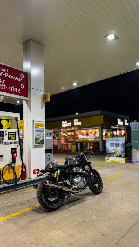 an image of a motorcycle parked by the gas pump