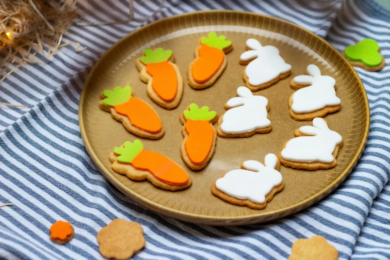 a plate that has many cookies with carrots on it