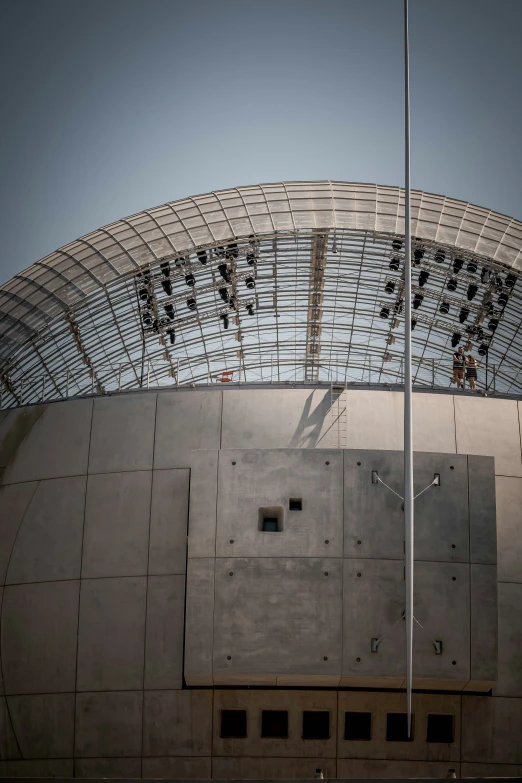 a white metal building with a flag flying from it's pole