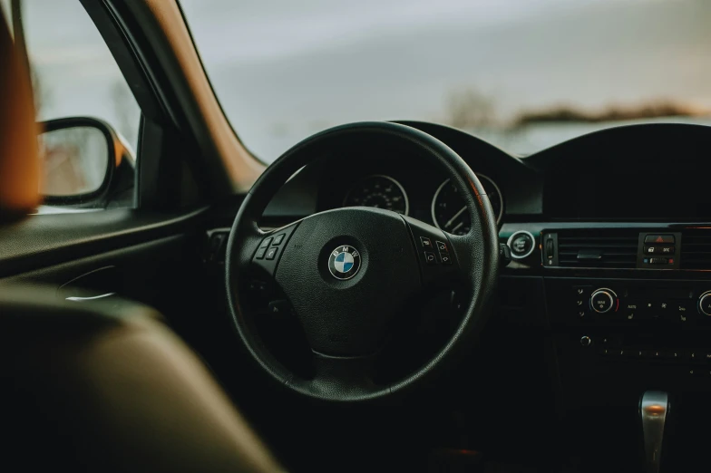 the inside of a car is shown, it has its dashboard and steering wheel visible