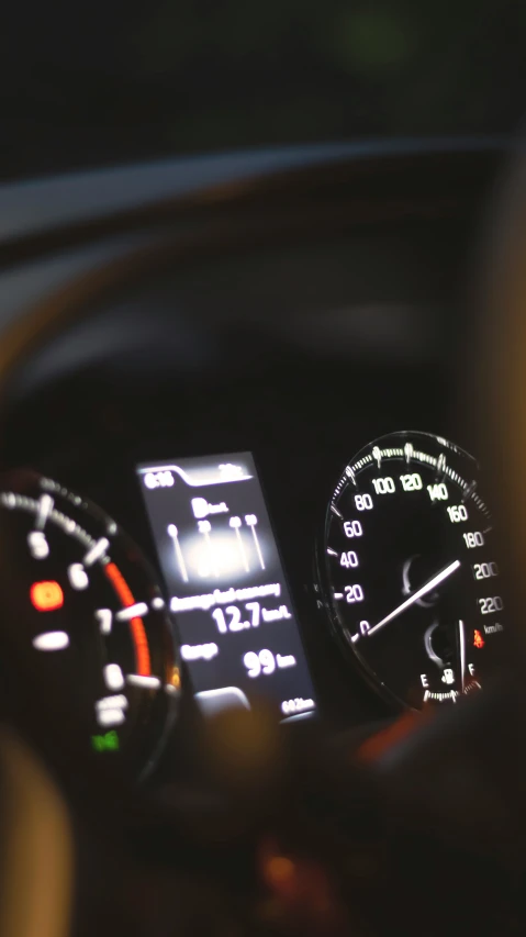 the interior view of a car with illuminated gauges